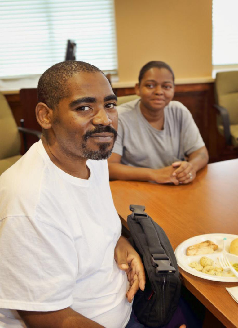 Man who left a testimonial poses for a picture with a family member.
